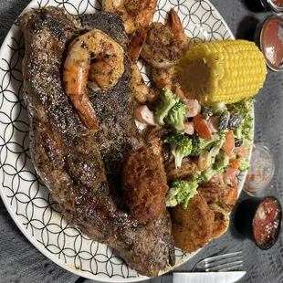 Steak and blackened shrimp with corn on the cob and broccoli salad. All very delicious