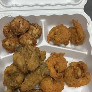 a tray of fried chicken and shrimp