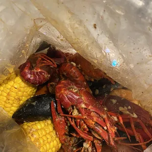 a craw and corn in a plastic bag