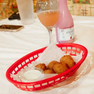 a basket of food and a glass of wine
