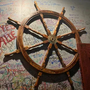 a ship's wheel on the wall