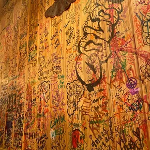 a wall covered in graffiti