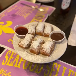 Beignets with raspberry and chocolate sauces