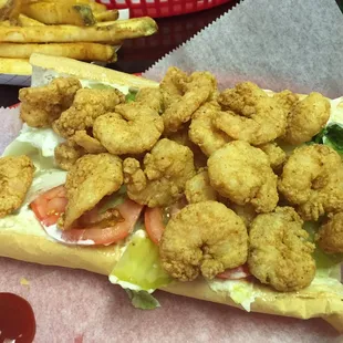 A full 8'' fried shrimp po boy. Yummy and overflowing with shrimp.
