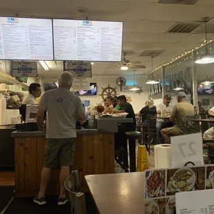 customers at the counter and menus