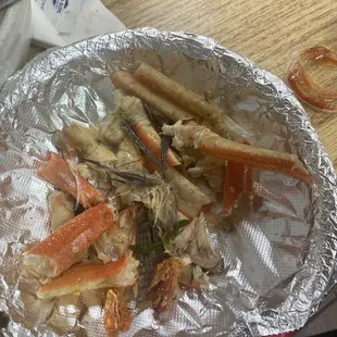 crab legs in foil on a table