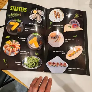 a hand holding a menu