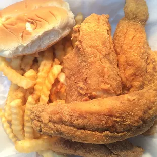 a chicken sandwich and fries in a styrofoam container