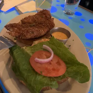 Crispy Cajun Catfish Sandwich Lettuce, Tomato, Remoulade Sauce on a Sesame Roll