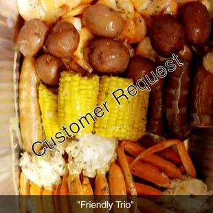 a container of shrimp, corn, and sausage