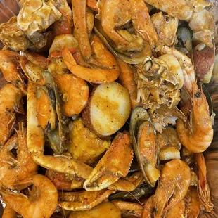 Crab leg, shrimp, mussel with potato and corn