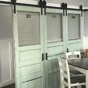 a dining room with a table and chairs