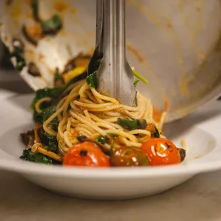a plate of food being eaten with a fork