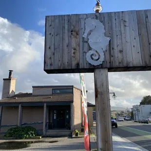 a wooden sign on a street corner