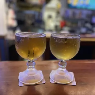 two glasses of beer on a table