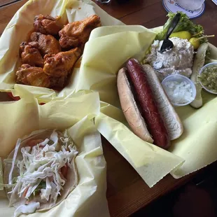 Buffalo wings, shrimp taco and hotdog with potato salad.