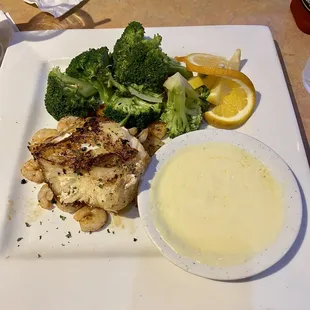 Grilled sea bass with sauce on the side, shrimp, &amp; steamed veggies.