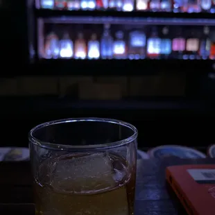 a glass of whiskey on a coaster