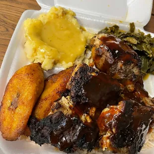 Jerk Chicken with collard greens, plantains, and mashed potatoes with gravy