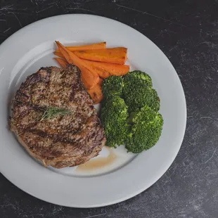 a steak, carrots and broccoli