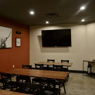 a dining room with a flat screen tv