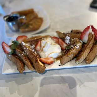 a plate of french toast and strawberries