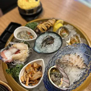 8/2022 Appetizer platter - fresh abalone, sea cucumber, sea squirt along with the shell (never seen the shell before). Oyster shooters!