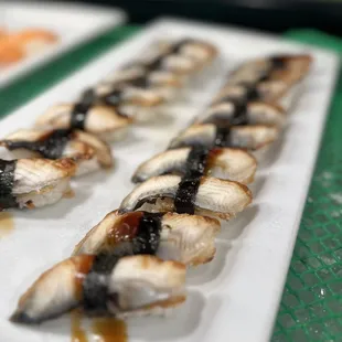 a variety of sushi on a white plate