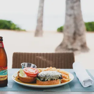a plate of food and a bottle of beer