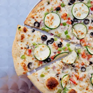 Veggie White: White Sauce, Zucchini, Bell Pepper, Tomato, Olives, Onion, Tomato