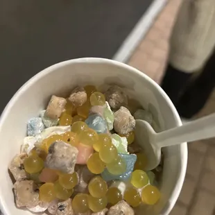 a person holding a cup filled with jellys