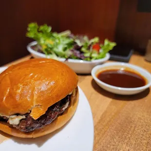 Burger with fondue cheese and side salad