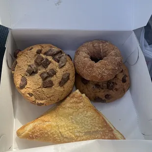 a box of doughnuts and a slice of cake