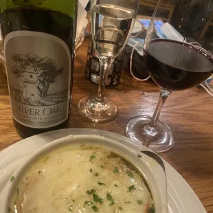 a bowl of soup and a bottle of wine