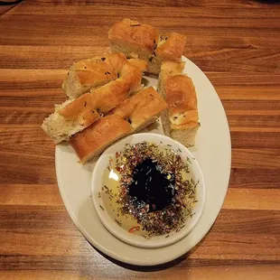 Artisinal homemade bread with herbs in olive oil &amp; vinegar