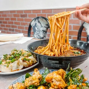 a plate of noodles being lifted by a fork