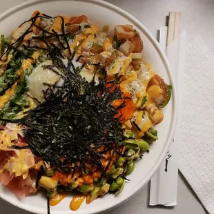 a bowl of sushi and vegetables