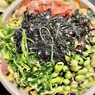 a bowl of sushi and vegetables