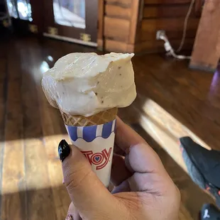  a hand holding an ice cream cone