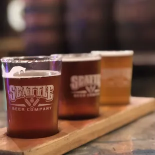 three glasses of beer on a wooden tray