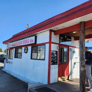 a man standing outside of a restaurant