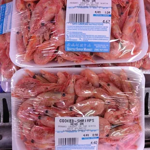 two trays of cooked shrimp