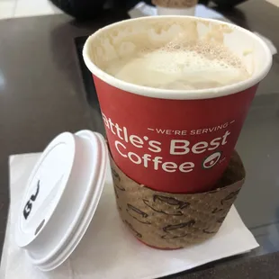 What's inside: a steaming hot white &amp; black mocha, labeled on the lid, the remnants of milk foam slowly melting into the liquid.