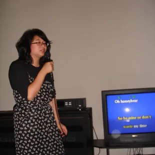 a woman standing in front of a tv