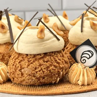 a plate of cupcakes with frosting and nuts