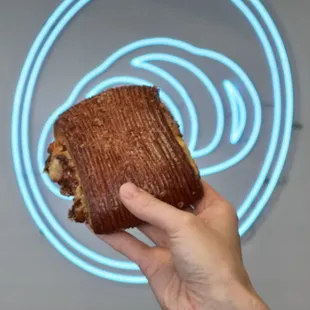 a hand holding a half eaten pastry