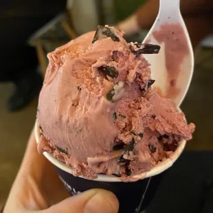 A bitten into scoop of raspberry chocolate chip.
