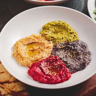 a bowl of hummus and pita chips