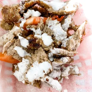 a half eaten sandwich in a paper wrapper