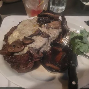 a steak with mushrooms and gravy